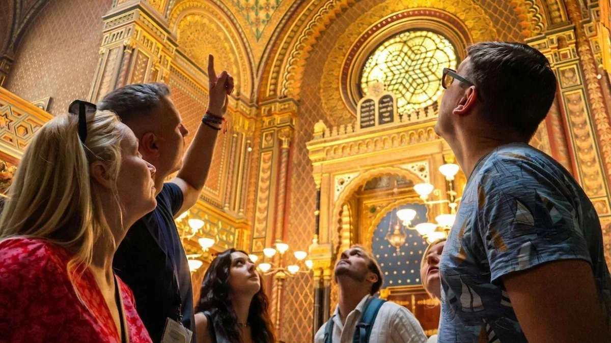 Guide leading a small group through Josefov on a Prague Jewish Quarter tour with synagogue admission tickets